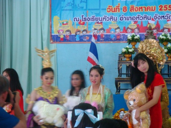 Miss Singapore on the right holding her trophy