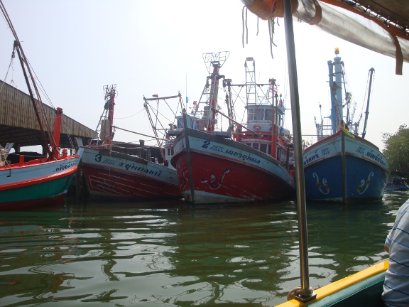 Back across the Pranburi River, passing Pak Nam Pran's colourful fishing fleet once more.