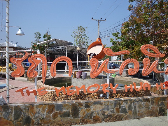 Complex sign with fountain behind during day