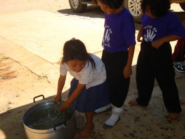 they all lined up to wash their hands in this saucepan – no soap, just hands in the water