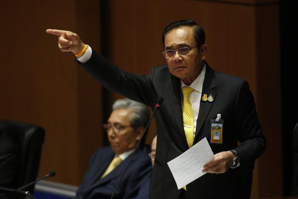 Prime Minister Prayut Chan-o-cha rises from his seat to make a point during a face-off with the opposition in a fiery parliamentary debate on the government's policy manifesto on Thursday.  Pattarapong Chatpattarasill