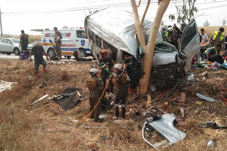 Rescue workers try to retrieve injured passengers from a van after it crashed into a tree in Ko Kha district of Lampang on Saturday. (Photo from @rescuelampang Facebook page)
