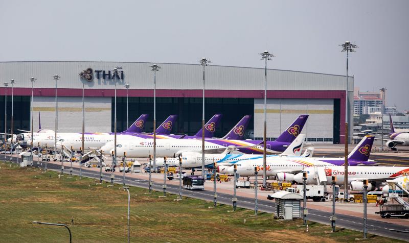 Thai Airways aircraft are parked on the tarmac at Suvarnabhumi Airport in Bangkok on March 25, 2020 as the airline suspended international flights due to the Covid-19 coronavirus. (AFP file photo)